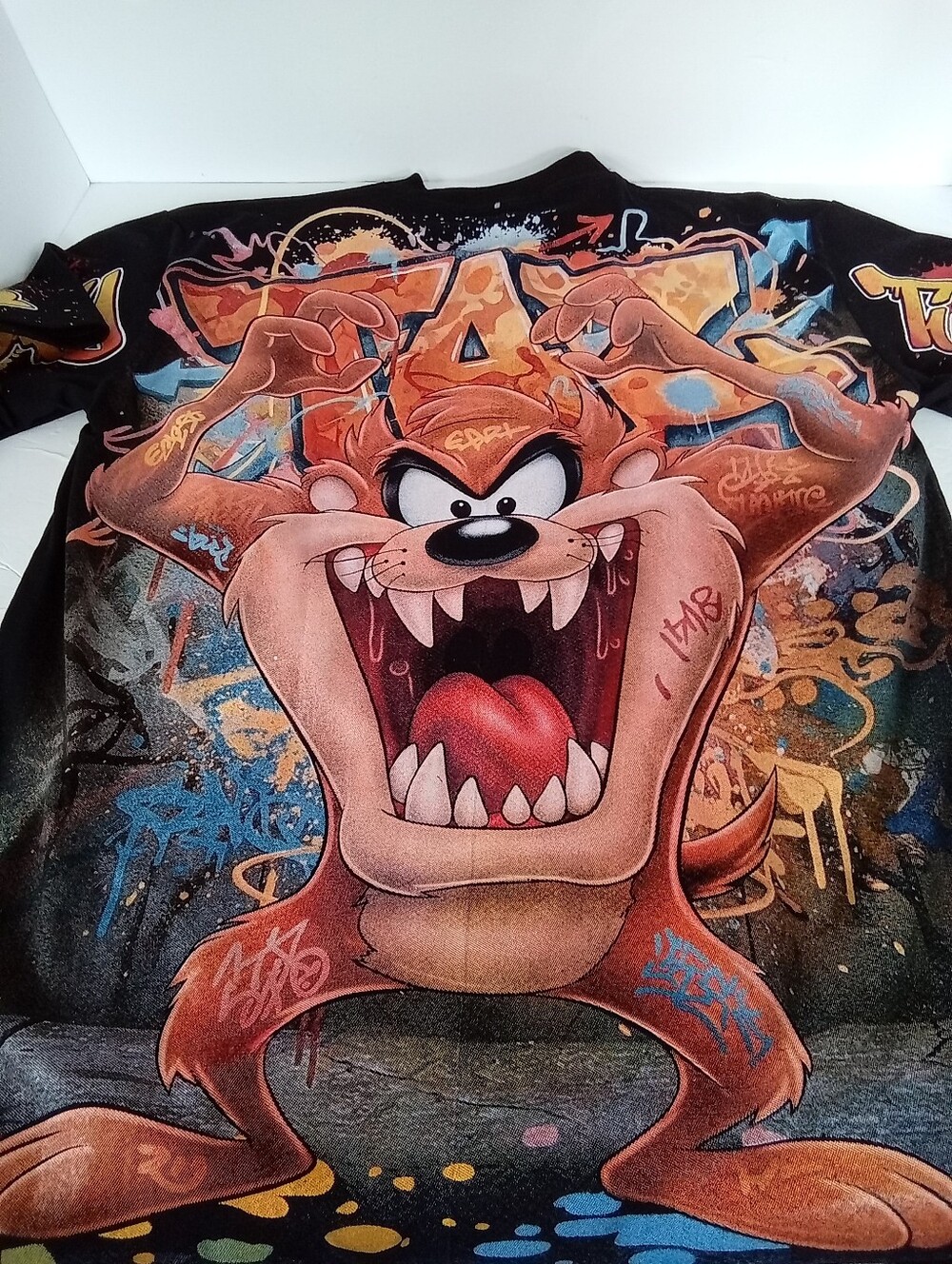 Apple Black Taz AOP Graphic Tee with Gold Logo and Multicolor Front Print - Picture 2 of 10
